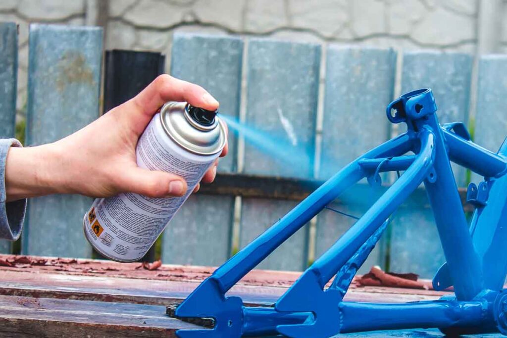 Close up of hand using spray paint, representing the Rust-Oleum class action.