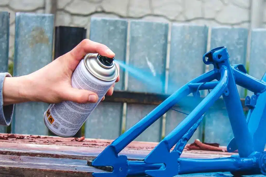 Close up of hand using spray paint, representing the Rust-Oleum class action.
