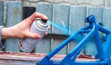 Close up of hand using spray paint, representing the Rust-Oleum class action.