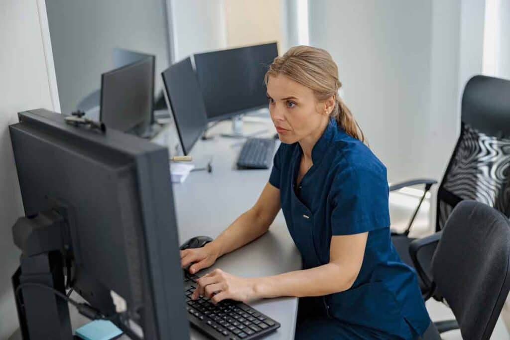 A nurse using a computer, representing the Cummins Behavioral Health System settlement.