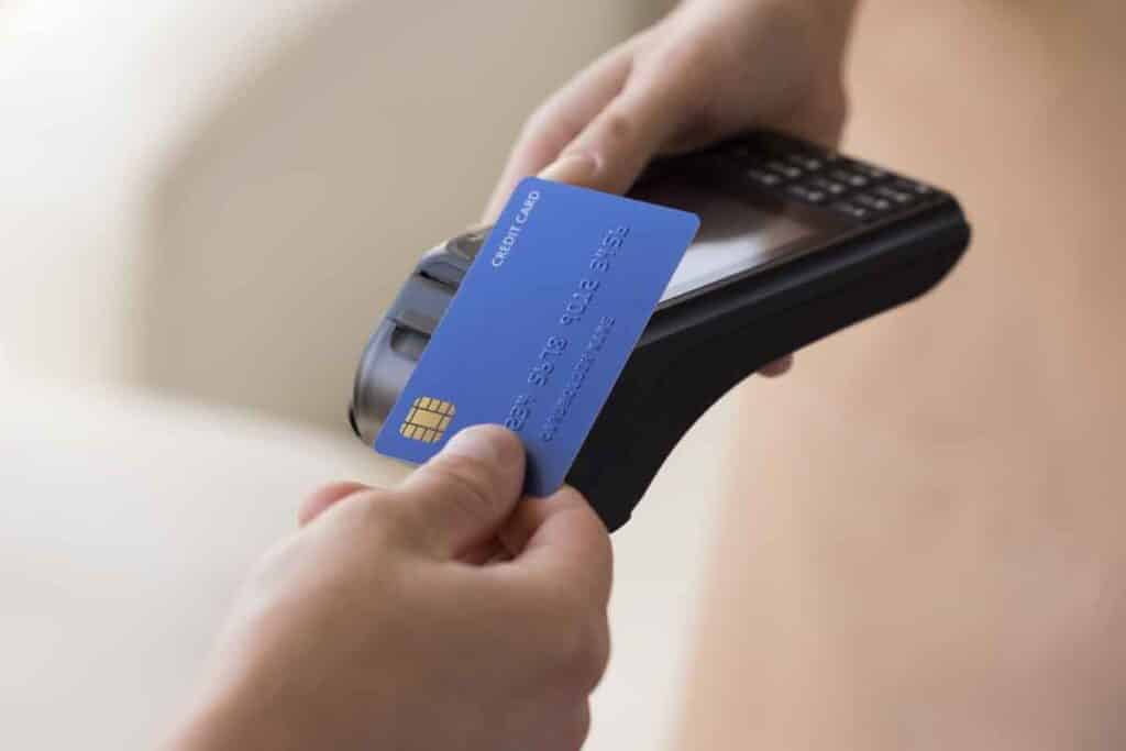 Close up of a person paying with a bank card, representing the STAR Financial settlement.