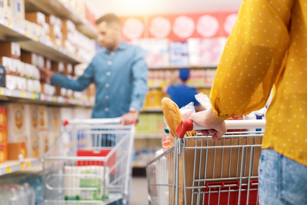People shopping at a grocery store with a cart in tow representing top recalls for the week of Nov. 11.