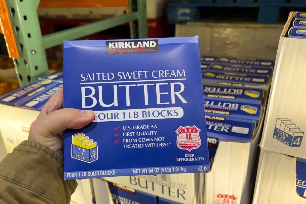 Hand holding Kirkland sweet cream butter, representing Costco recall.