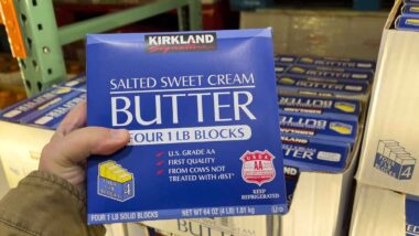 Hand holding Kirkland sweet cream butter, representing Costco recall.