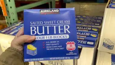 Hand holding Kirkland sweet cream butter, representing Costco recall.