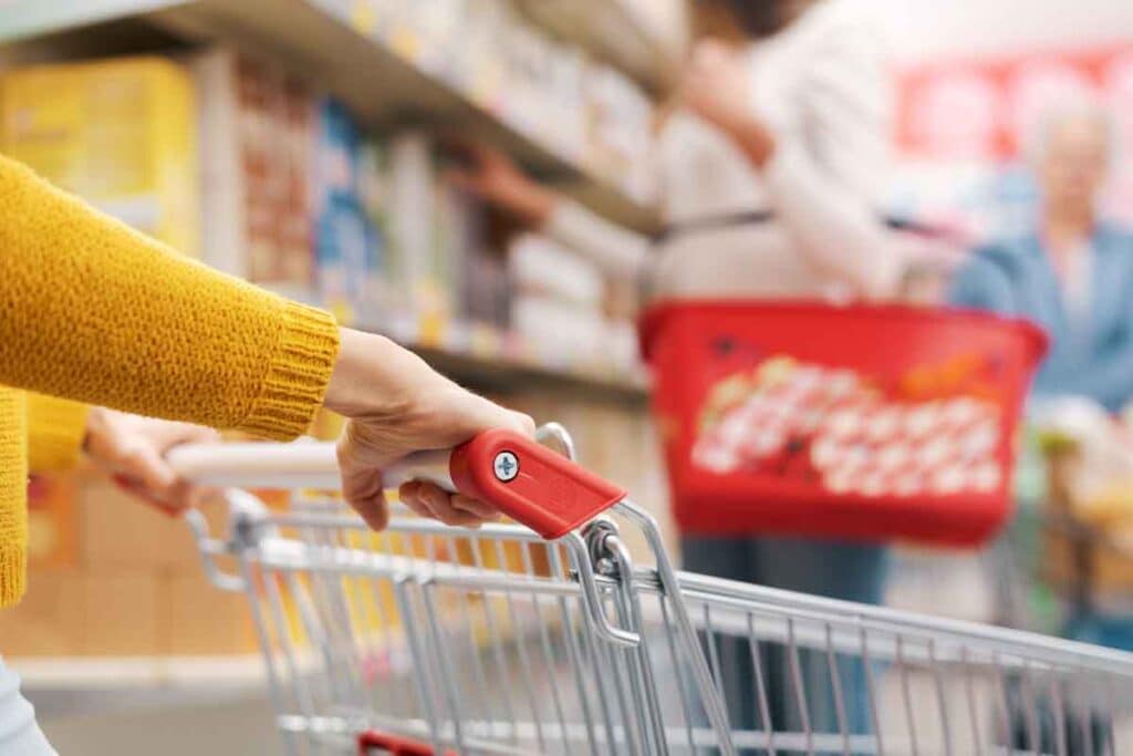 Close up of hands pushing a shopping cart, representing top recalls for the week of Nov. 4.