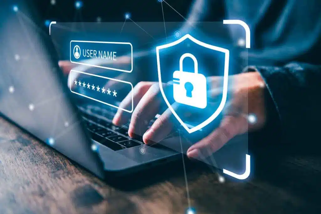 Hands typing on a laptop with a data breach concept overlay, representing recent data breaches.