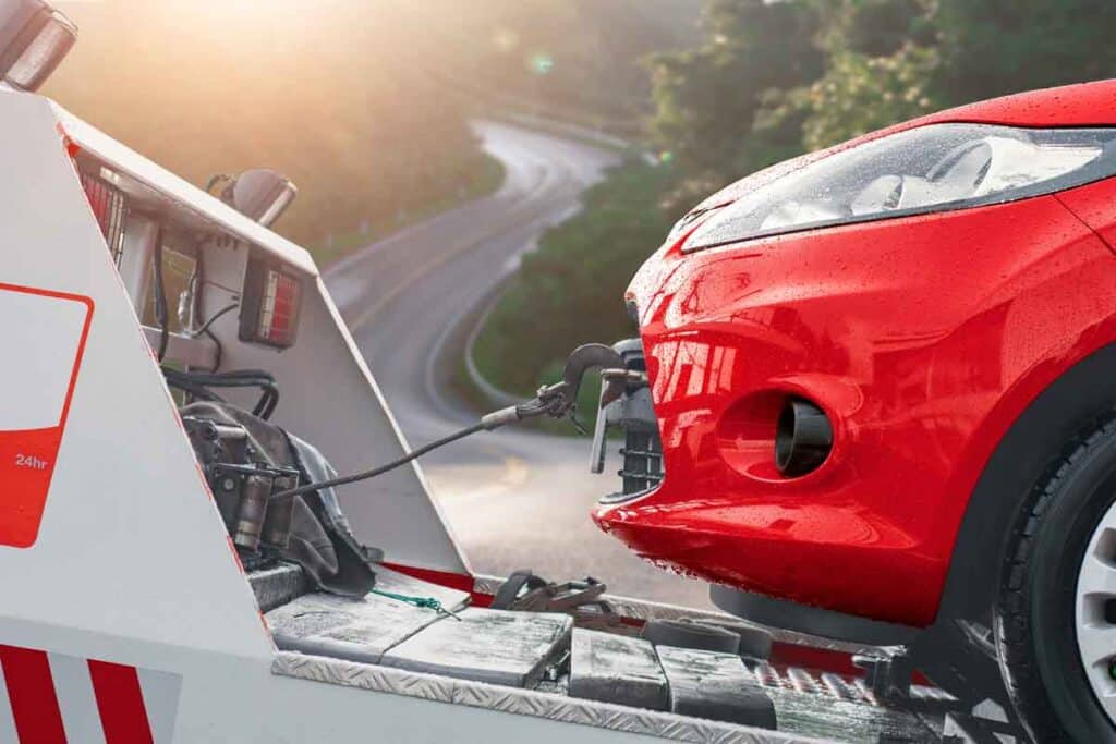 Close up of red car being towed, representing the Tri County Area Federal Credit Union settlement
