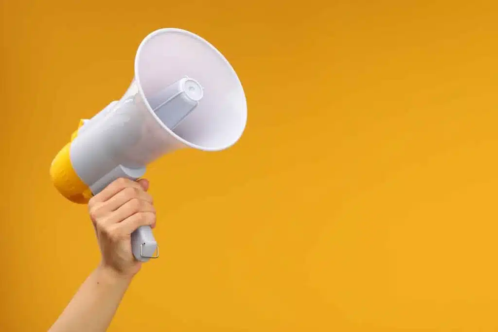 Close up of a hand holding a megaphone, representing top recalls for the week of Nov. 18.