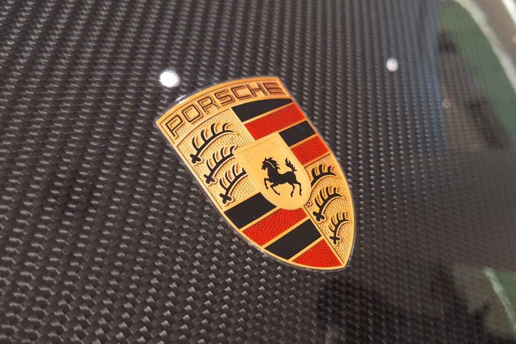 Close up of Porsche emblem on a front bumper, representing the Porsche sunroof settlement.