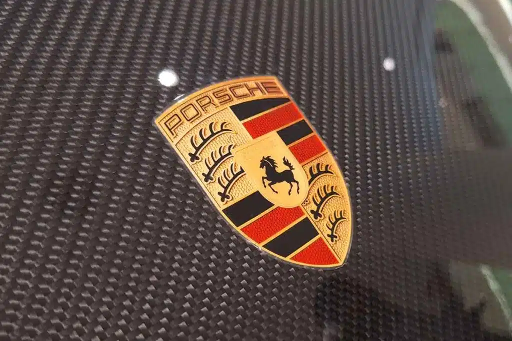 Close up of Porsche emblem on a front bumper, representing the Porsche sunroof settlement.
