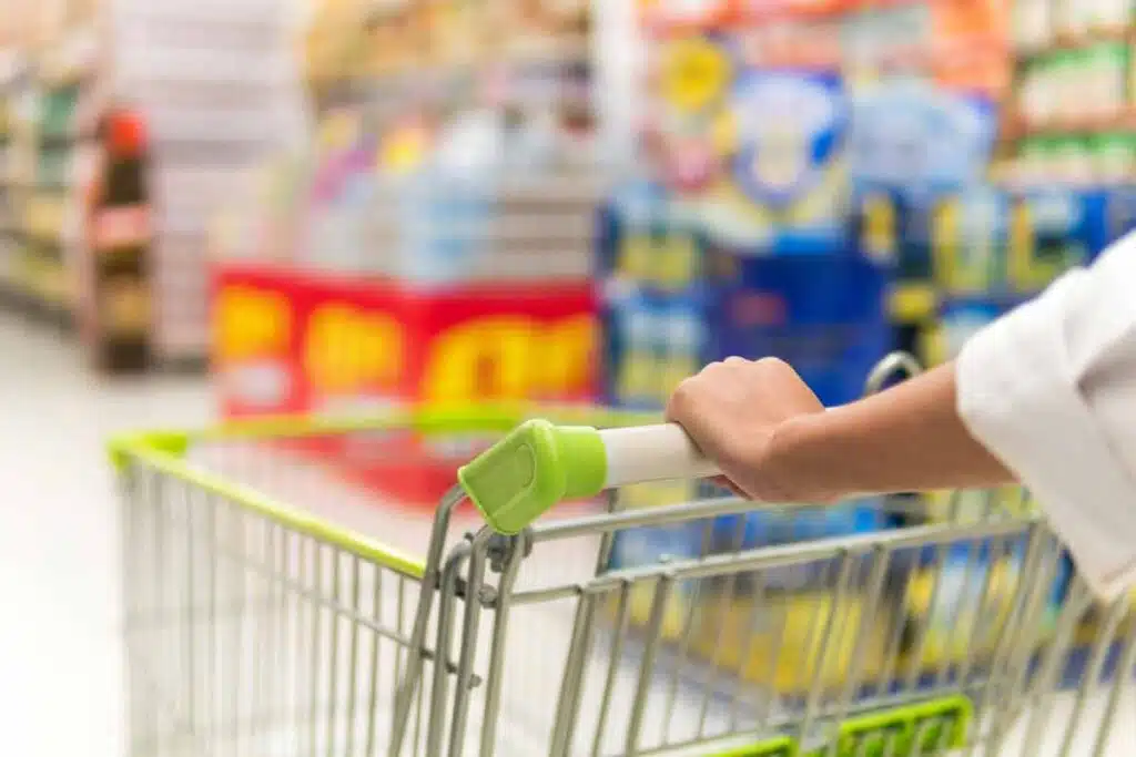 Close up of a woman pushing a shopping cart, representing top recalls for the week of Nov. 25.
