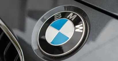 Close up of a BMW emblem on a front bumper, representing the BMW class action.