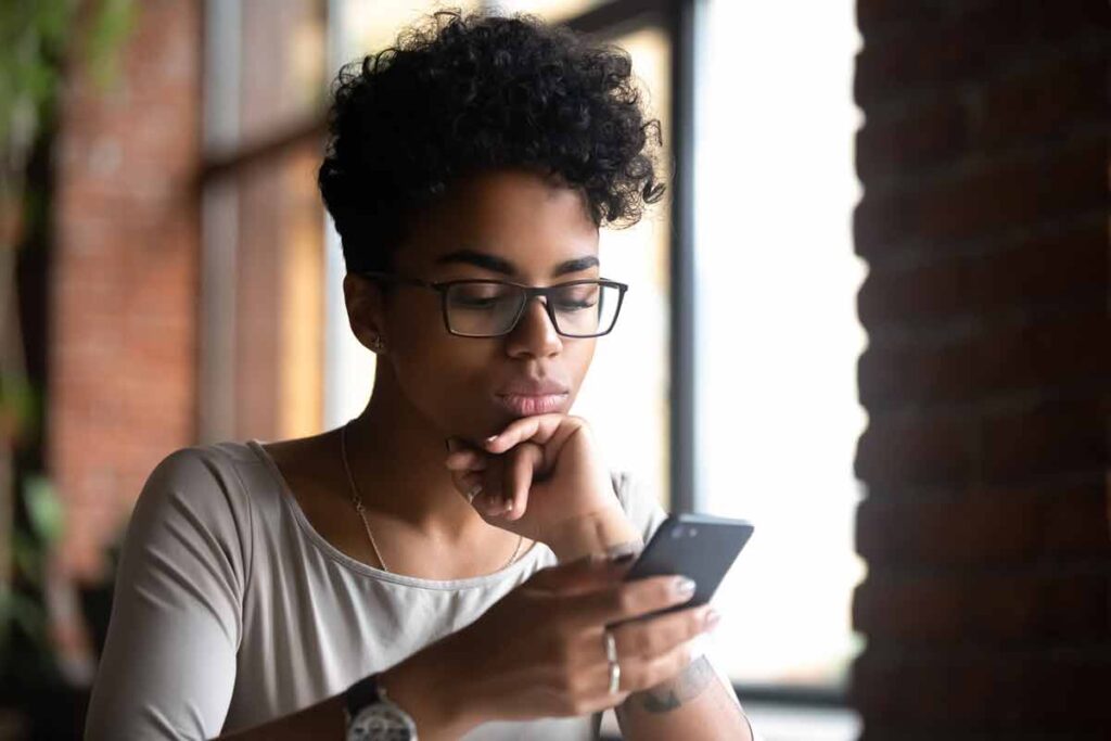 Woman using a smartphone, representing the fertility-tracking app, Inito.