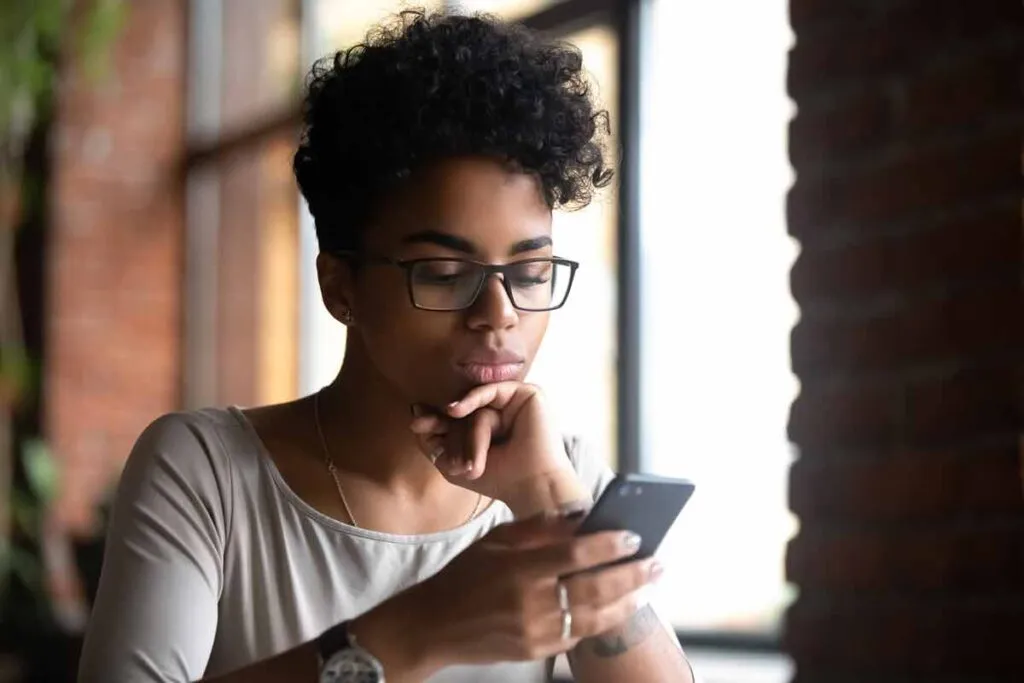 Woman using a smartphone, representing the fertility-tracking app, Inito.