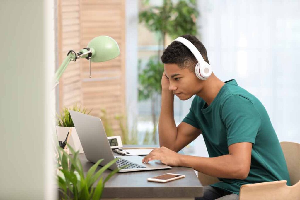 A teenage boy using a computer, representing the Brightline settlement.