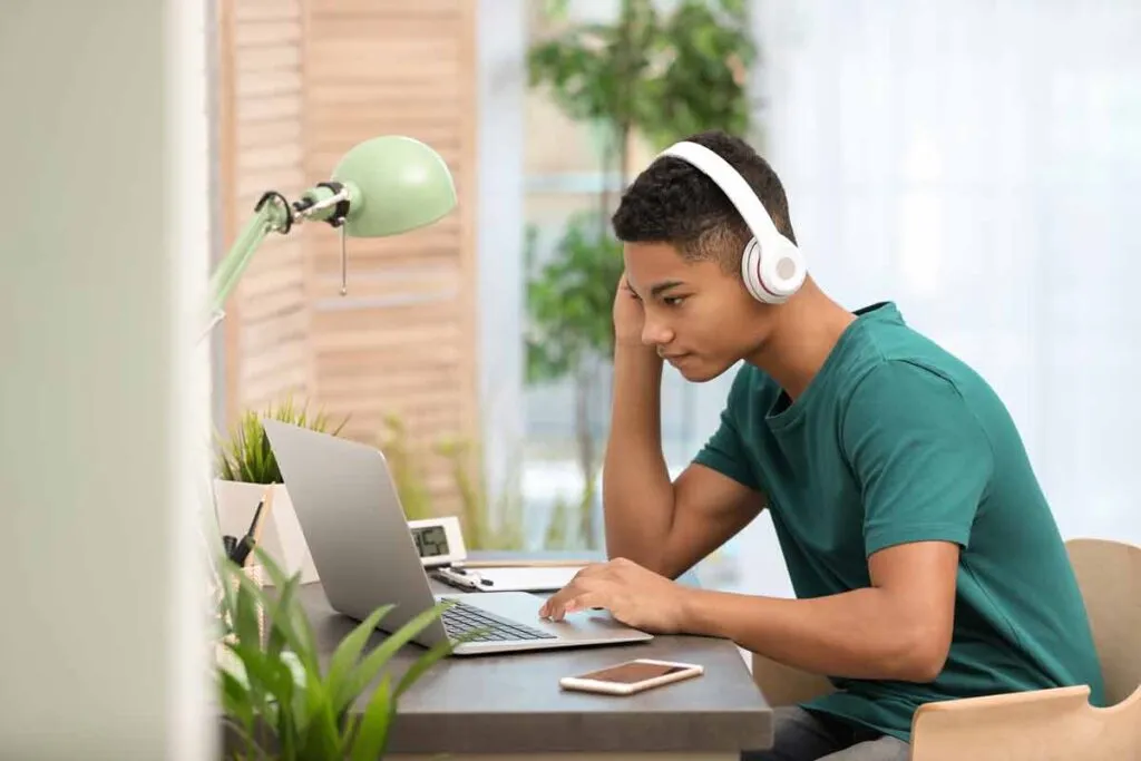 A teenage boy using a computer, representing the Brightline settlement.