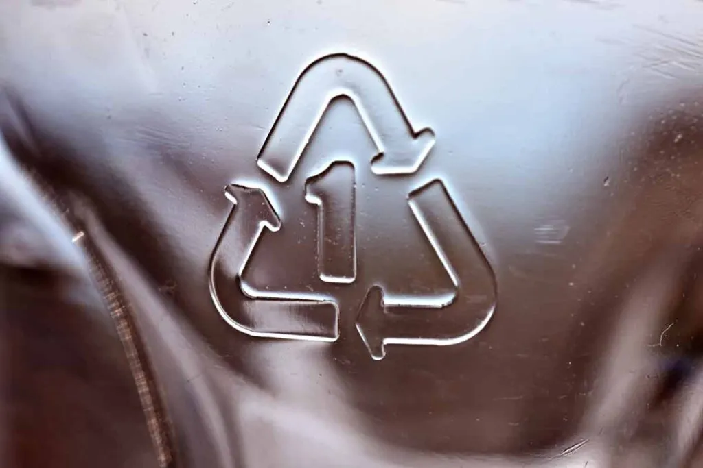 Close up of recycle symbol on plastic, representing plastic recyclability.