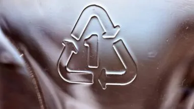 Close up of recycle symbol on plastic, representing plastic recyclability.