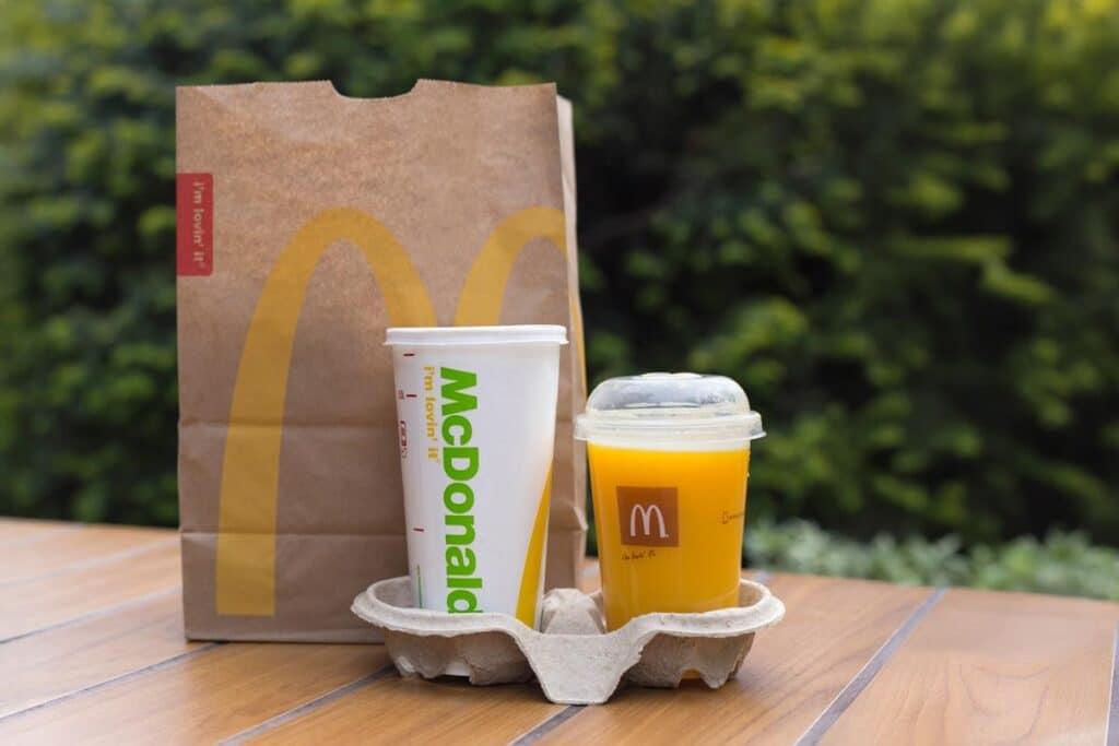 McDonald's orange juice, next to a McDonald's cup and bag, representing the McDonald's class action.