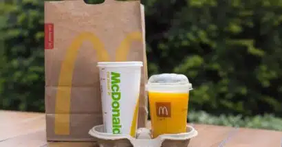 McDonald's orange juice, next to a McDonald's cup and bag, representing the McDonald's class action.