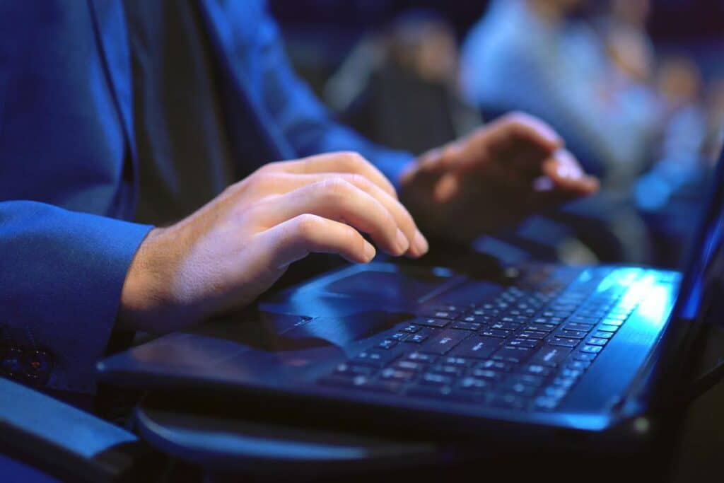 Close up of hands using a laptop, representing the Cinfed Federal Credit Union settlement.