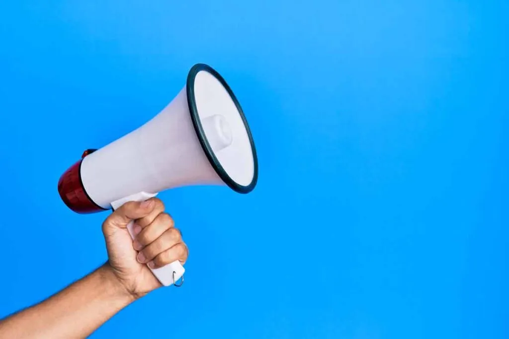 Close up of hand holding a megaphone, representing top recalls for the week of Dec. 16.