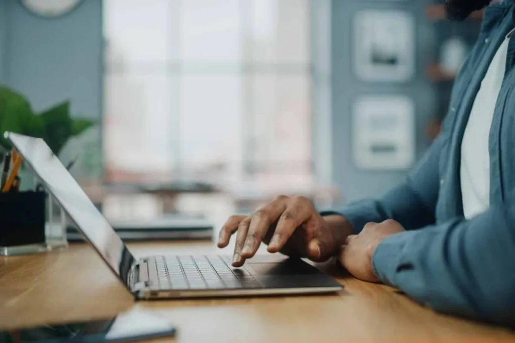 Close up of hands typing on a laptop, representing the Kaye-Smith Enterprises settlement.