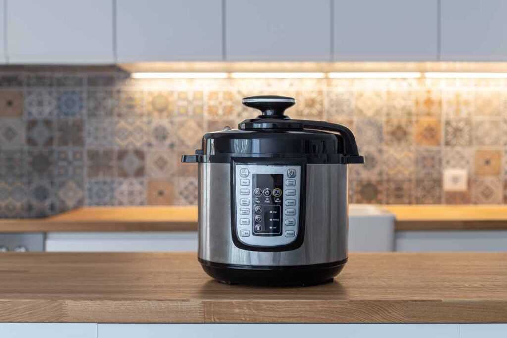A pressure cooker on a kitchen counter, representing the Sunbeam pressure cooker verdict.