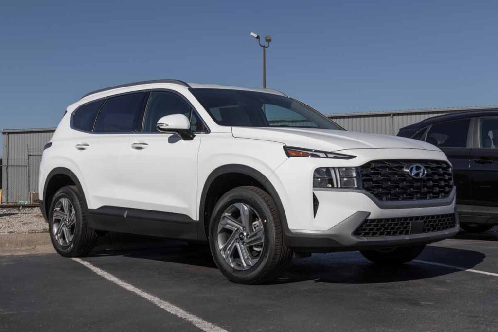 A white Hyundai Santa Fe in a parking lot, representing the Hyundai recall.