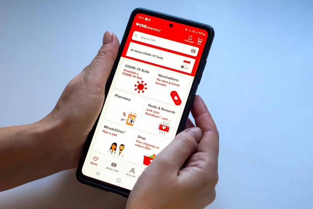 Close up of hands using the CVS app, representing the CVS class action.