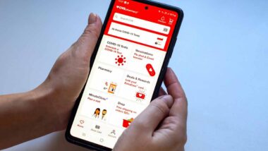 Close up of hands using the CVS app, representing the CVS class action.