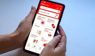 Close up of hands using the CVS app, representing the CVS class action.