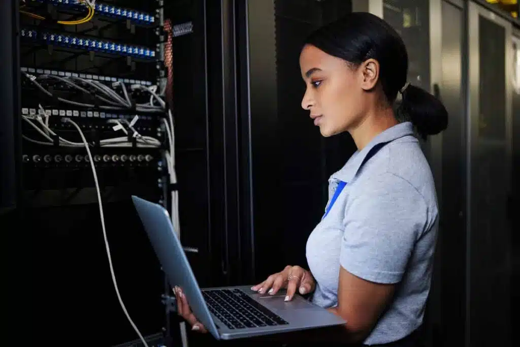 IT worker working in a server room, representing the Automation Personnel Services settlement.