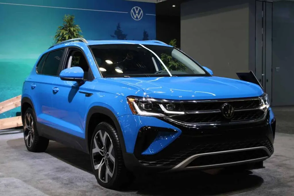 A blue 2023 Volkswagen Atlas at a car show, representing the Volkswagen Atlas class action settlement.