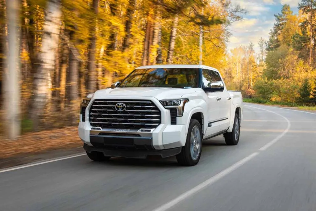 A white Toyota Tundra driving along a road, representing the Toyota class action.