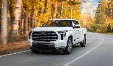 A white Toyota Tundra driving along a road, representing the Toyota class action.
