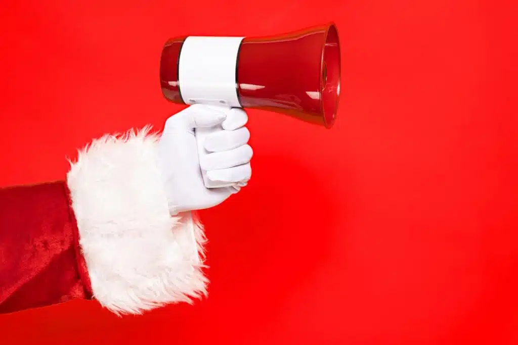 Santas hand holding a megaphone, representing the holiday recalls.