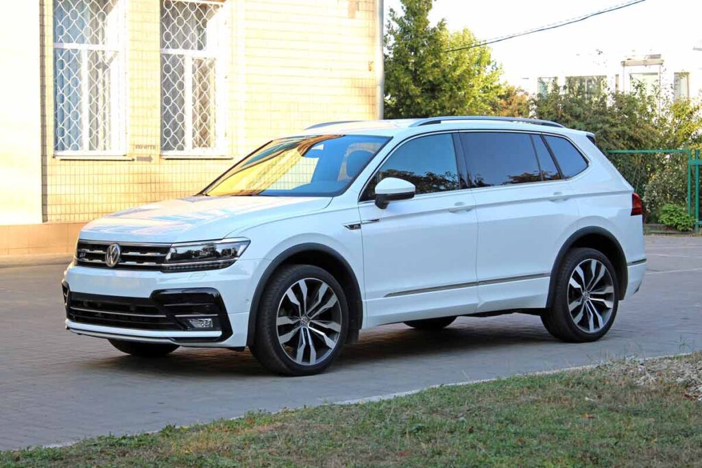A white Volkswagen Tiguan in a driveway, representing the VW class action.