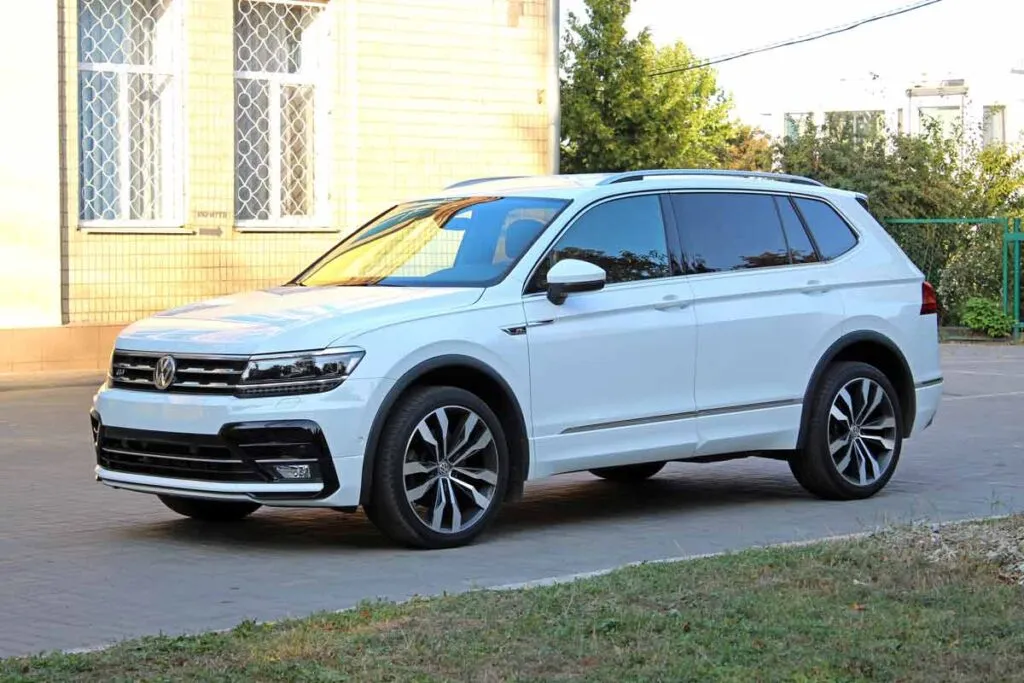 A white Volkswagen Tiguan in a driveway, representing the VW class action.