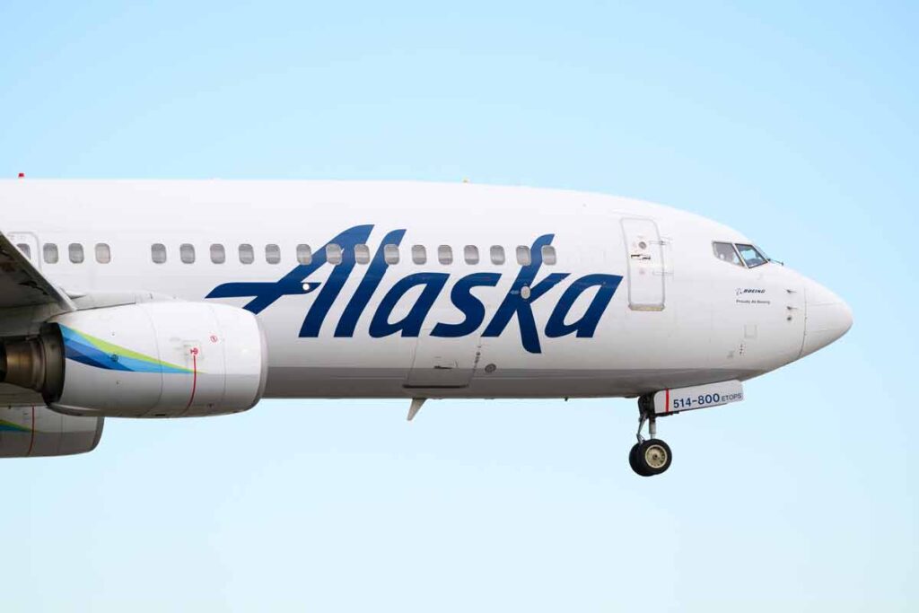 An Alaska Airlines plane in flight, representing the Alaska Airlines pilot settlement.