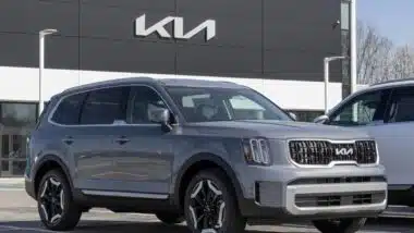 A 2024 gray Kia Telluride in front of a Kia dealership, representing the Kia class action.