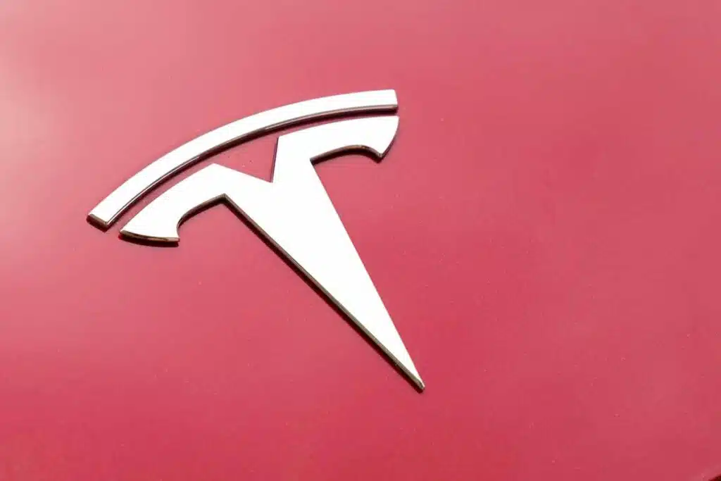 Close up of Tesla emblem on a front bumper, representing the Tesla recall.