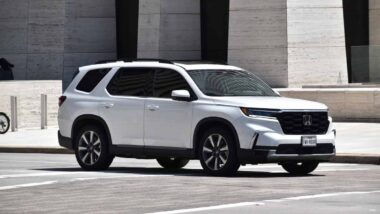A 2024 white Honda Pilot on a roadway, representing the Honda recall.