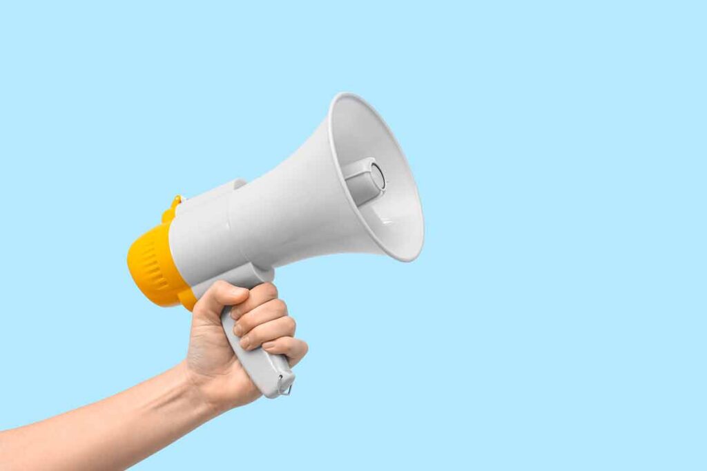 Close up of a hand holding a megaphone, representing top recalls for the week of Dec. 9.