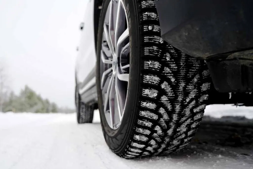 Close up of a car tire in the snow, representing the snow tire recall.