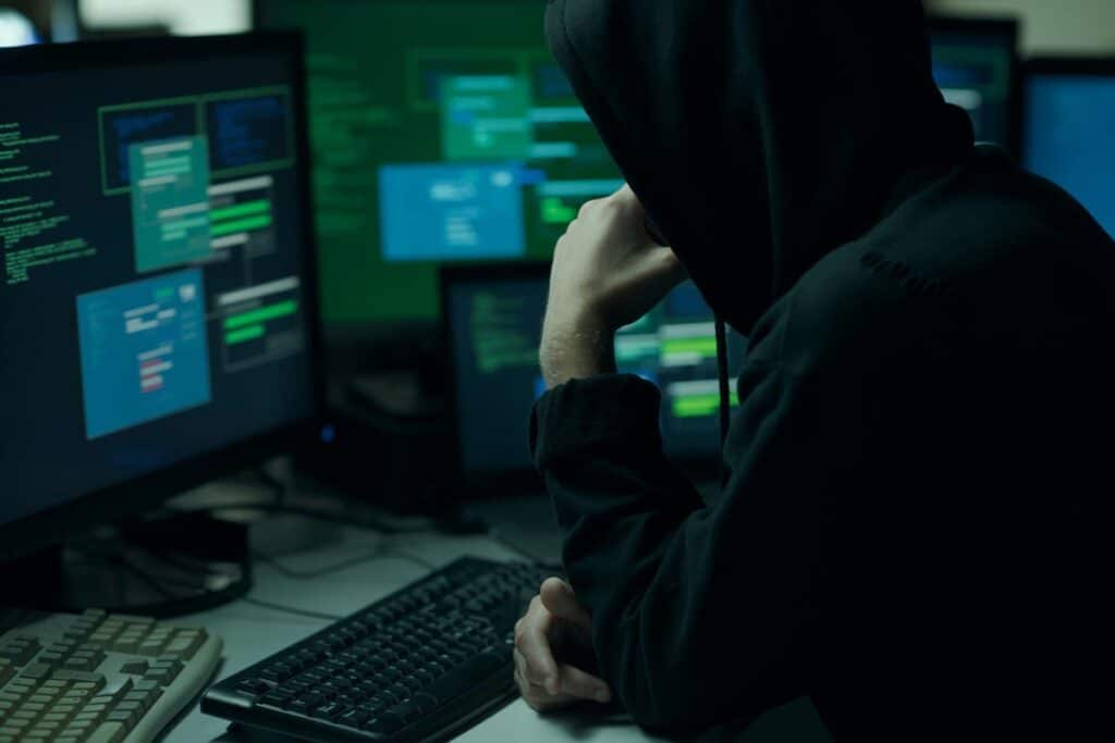 A hacker using a computer, representing the Treasury data breach.