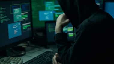 A hacker using a computer, representing the Treasury data breach.