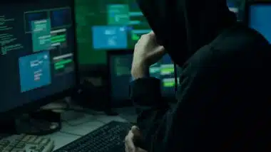 A hacker using a computer, representing the Treasury data breach.