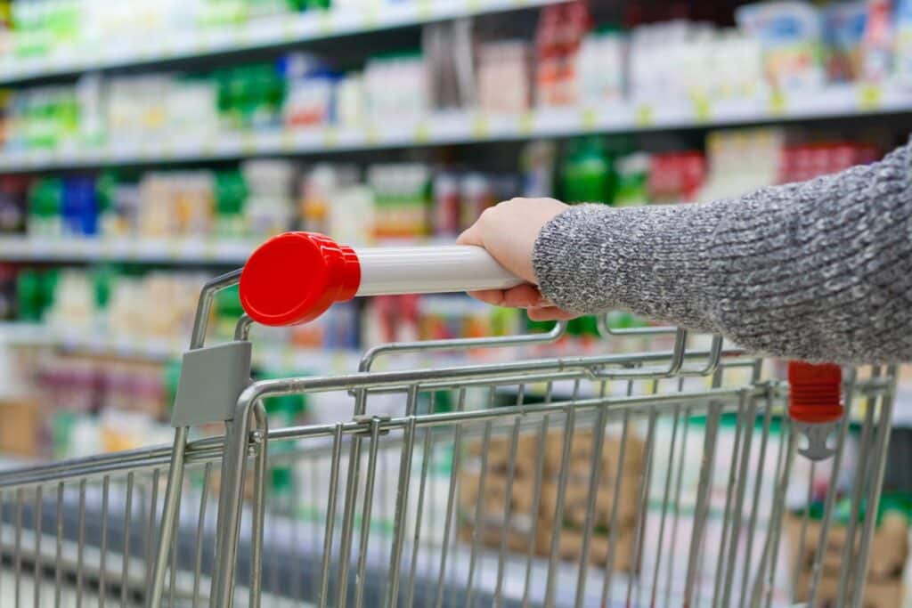 Close up of a woman pushing a shopping cart, representing false advertising.